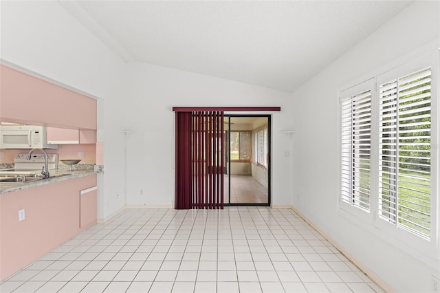 interior space featuring light tile patterned flooring and vaulted ceiling