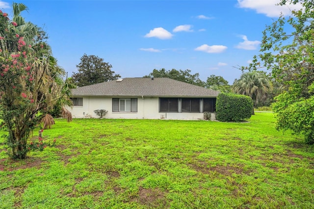 rear view of house with a lawn