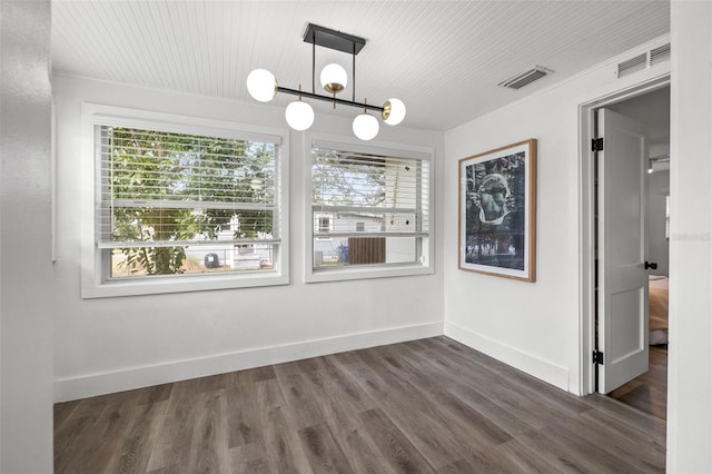 unfurnished dining area featuring dark hardwood / wood-style floors