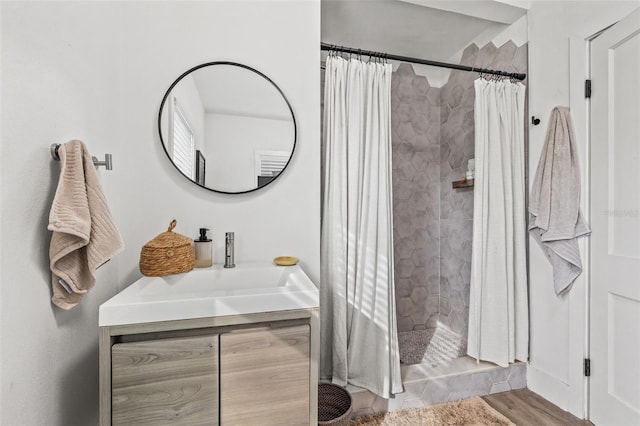 bathroom featuring hardwood / wood-style flooring, vanity, and curtained shower