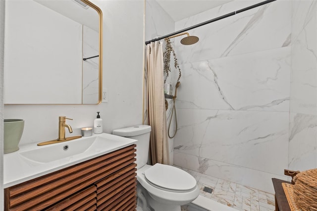 bathroom with vanity, curtained shower, and toilet