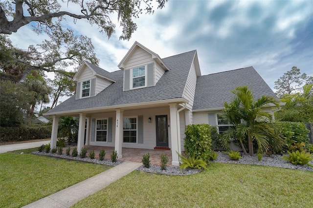 view of front of house featuring a porch and a front yard