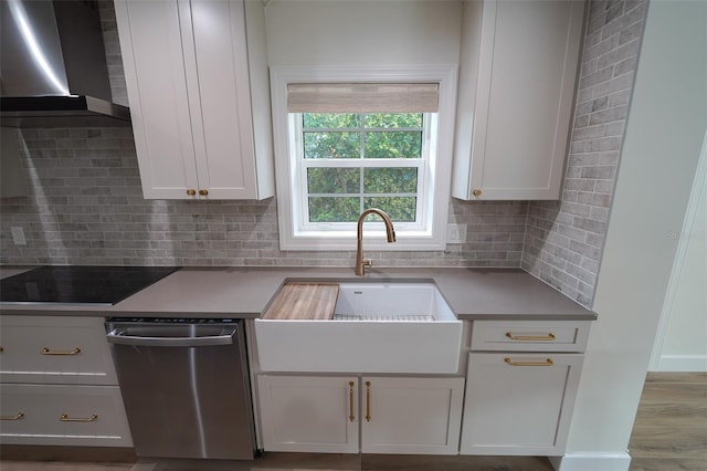 kitchen with sink, wall chimney range hood, dishwasher, black electric stovetop, and white cabinets