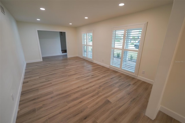 spare room with hardwood / wood-style flooring