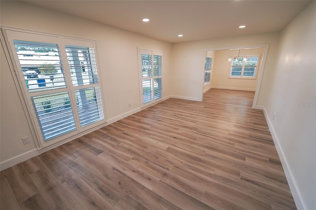 unfurnished room with hardwood / wood-style flooring