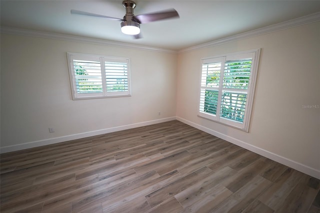 empty room featuring ceiling fan, ornamental molding, and dark hardwood / wood-style flooring