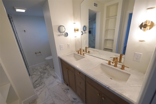 bathroom featuring vanity, walk in shower, built in features, and toilet