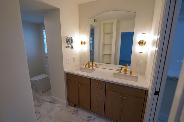 bathroom featuring vanity and toilet