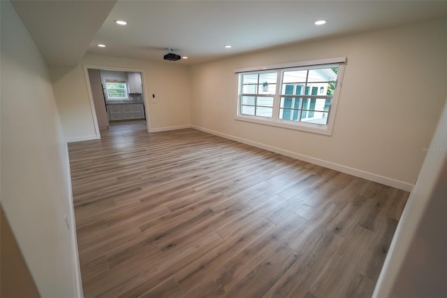 unfurnished room with hardwood / wood-style flooring