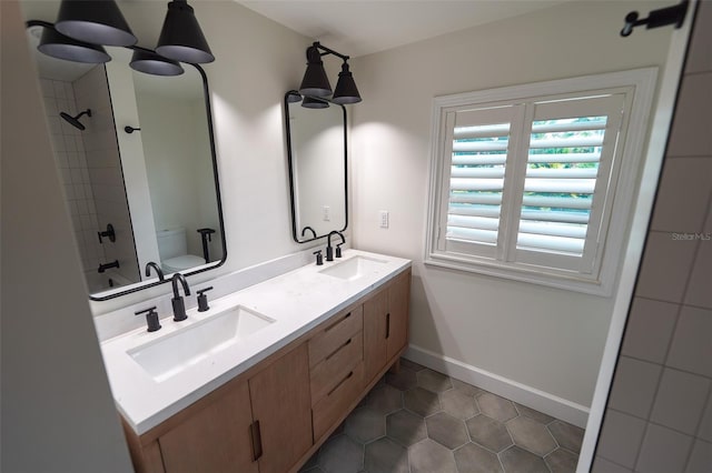 full bathroom featuring vanity, toilet, tiled shower / bath combo, and tile patterned flooring