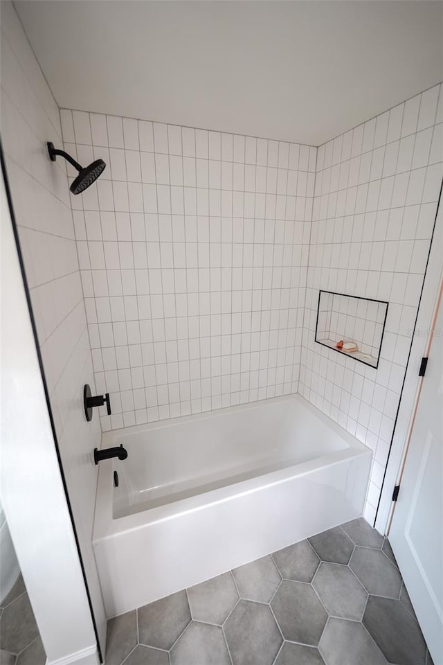 bathroom featuring tiled shower / bath and tile patterned floors