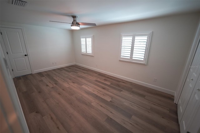 spare room featuring ceiling fan and dark hardwood / wood-style flooring