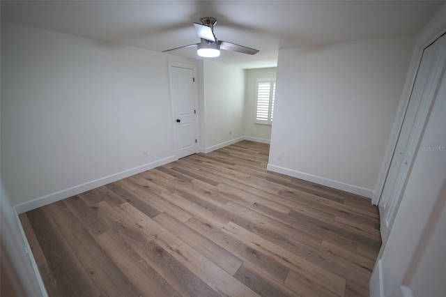 unfurnished bedroom with ceiling fan and light hardwood / wood-style floors