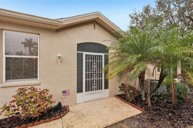 entrance to property with a patio area and central AC