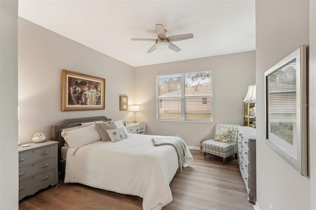 bedroom with hardwood / wood-style flooring and ceiling fan