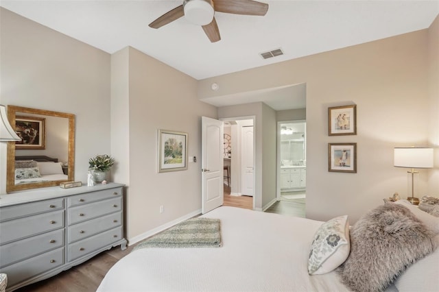 bedroom with light wood-type flooring, connected bathroom, and ceiling fan