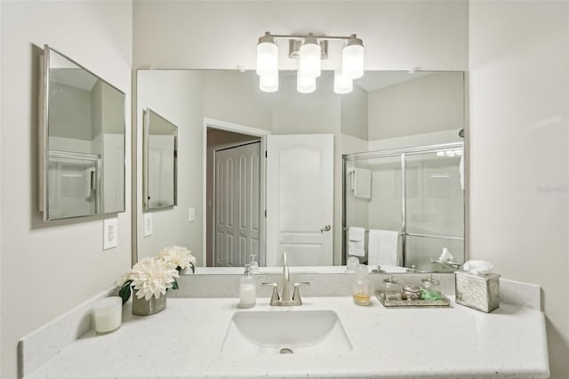 bathroom featuring an enclosed shower and vanity