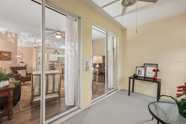 interior space with ceiling fan