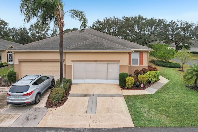 ranch-style house featuring a front yard and a garage