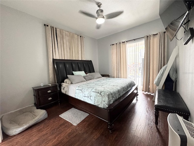 bedroom with ceiling fan and dark hardwood / wood-style flooring