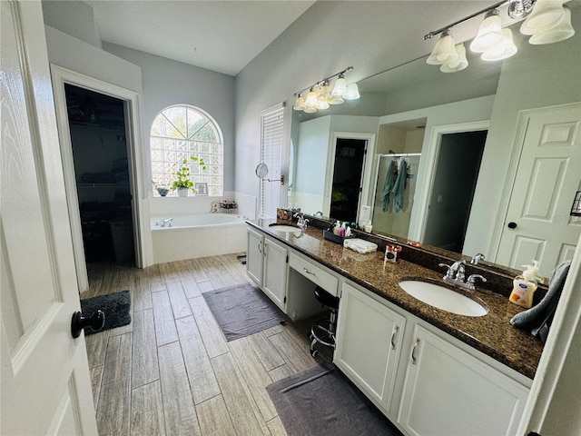 bathroom with independent shower and bath and vanity