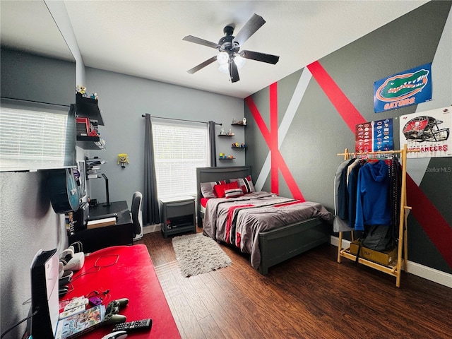 bedroom with ceiling fan and dark wood-type flooring