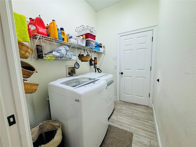 washroom with light hardwood / wood-style flooring and independent washer and dryer