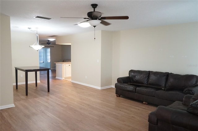 living room featuring light hardwood / wood-style floors and ceiling fan