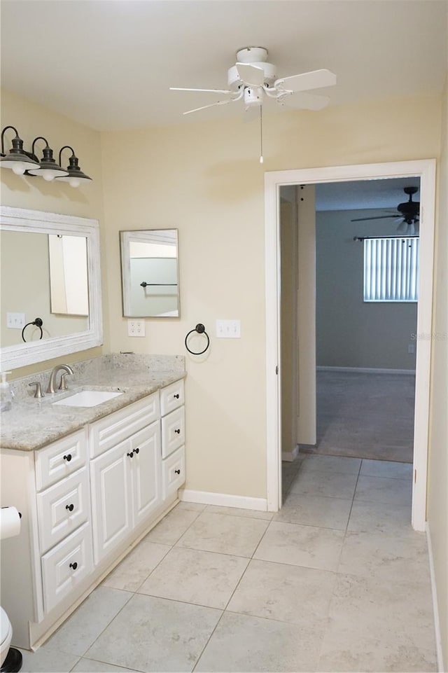 bathroom featuring ceiling fan, vanity, and tile patterned flooring