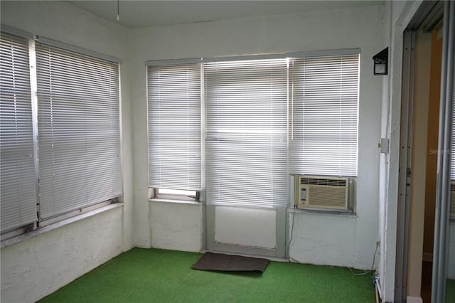 unfurnished sunroom with golf simulator and cooling unit