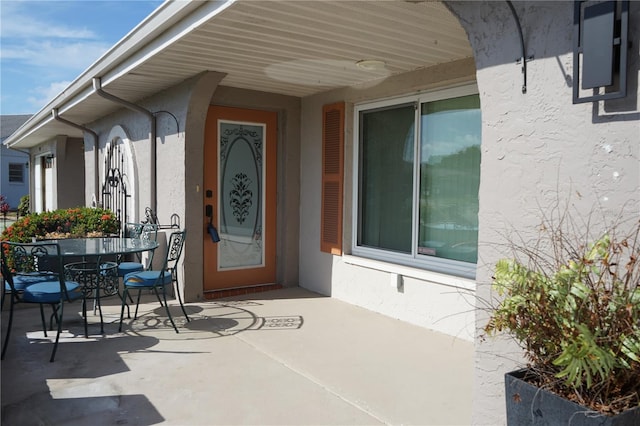 property entrance featuring a patio