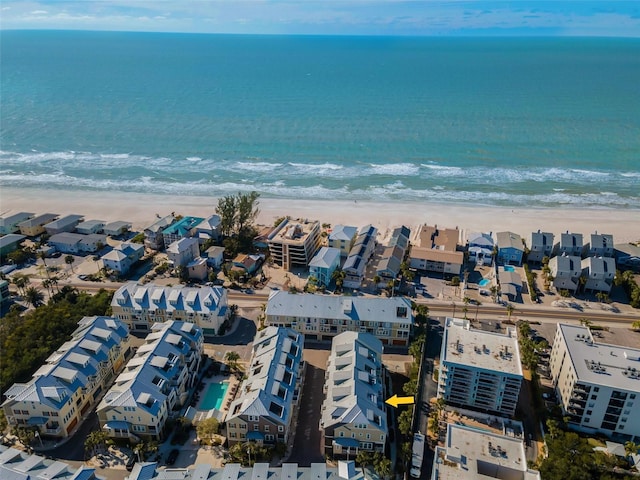 drone / aerial view with a beach view and a water view