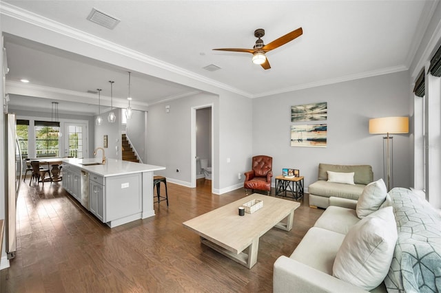 living room featuring ceiling fan, ornamental molding, dark hardwood / wood-style floors, and sink