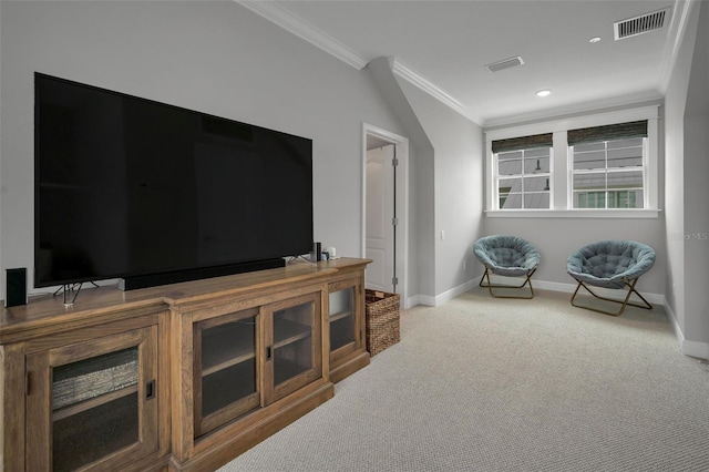 sitting room with ornamental molding and carpet floors