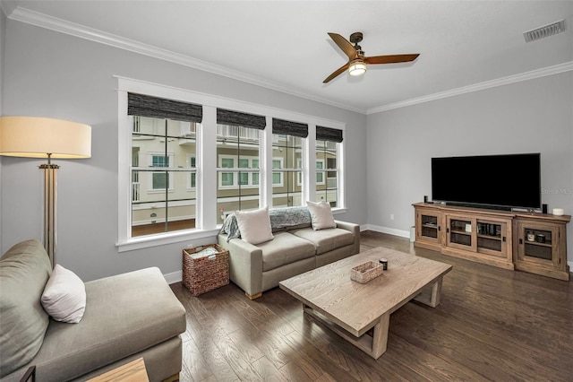 living room featuring crown molding, dark wood-type flooring, and ceiling fan