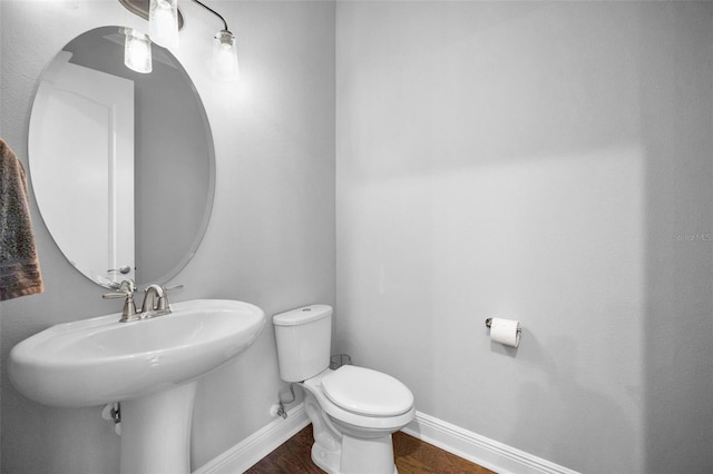 bathroom with toilet and hardwood / wood-style floors