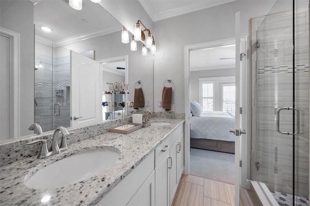 bathroom featuring ornamental molding, an enclosed shower, and vanity