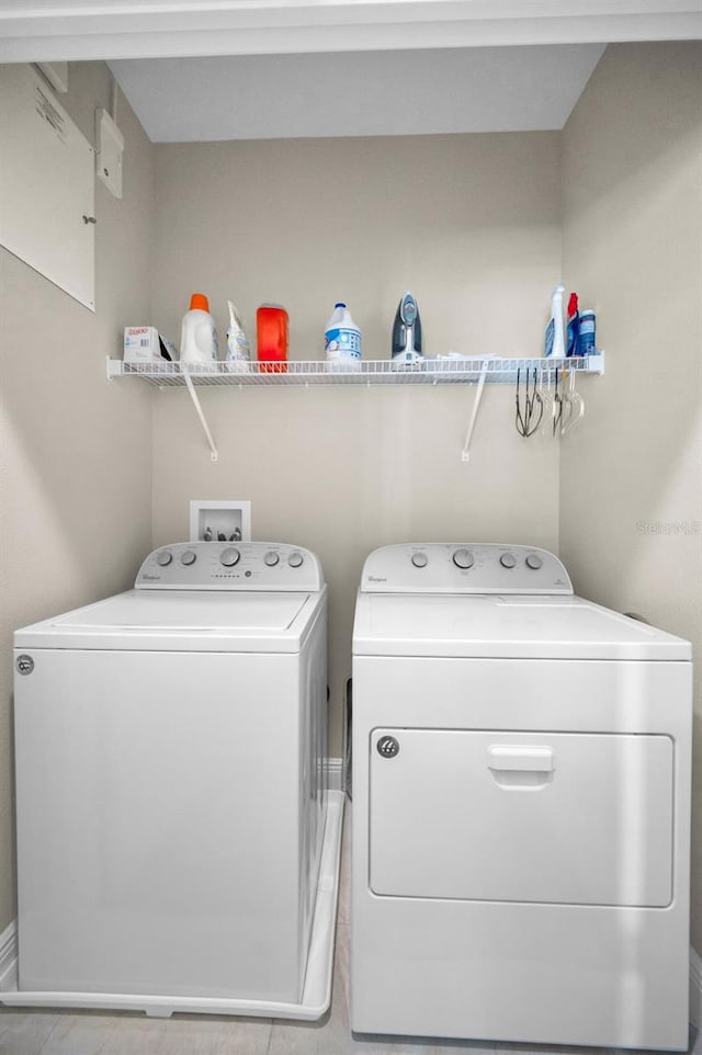 clothes washing area featuring separate washer and dryer