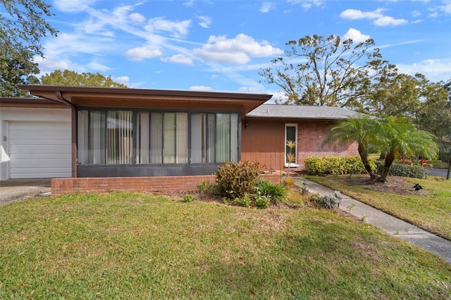 view of front of property with a garage and a front lawn