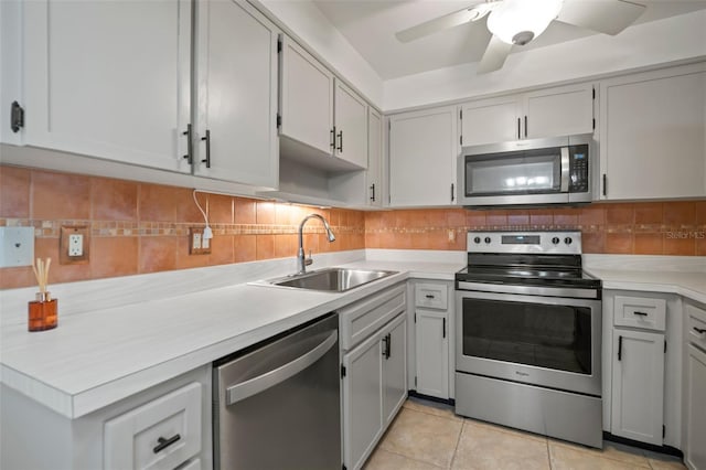 kitchen featuring sink, appliances with stainless steel finishes, tasteful backsplash, and light tile patterned flooring