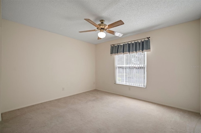 unfurnished room with light colored carpet, a textured ceiling, and ceiling fan