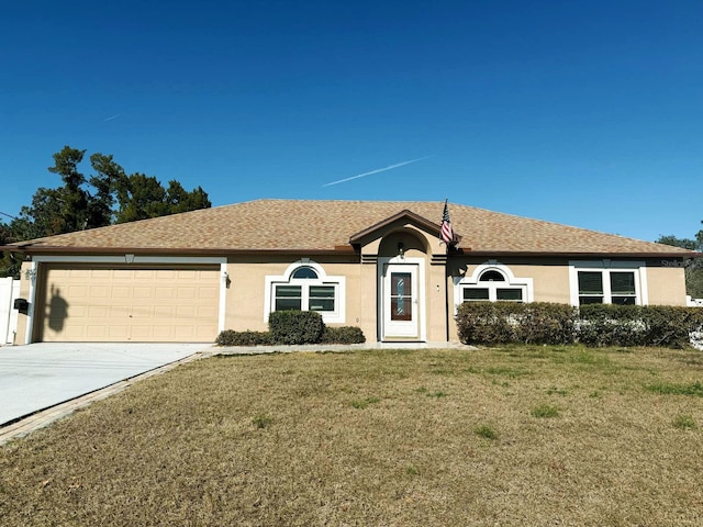 single story home featuring a garage and a front lawn