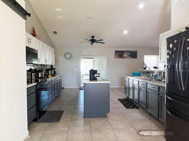 kitchen with sink, black appliances, a center island, decorative backsplash, and white cabinets