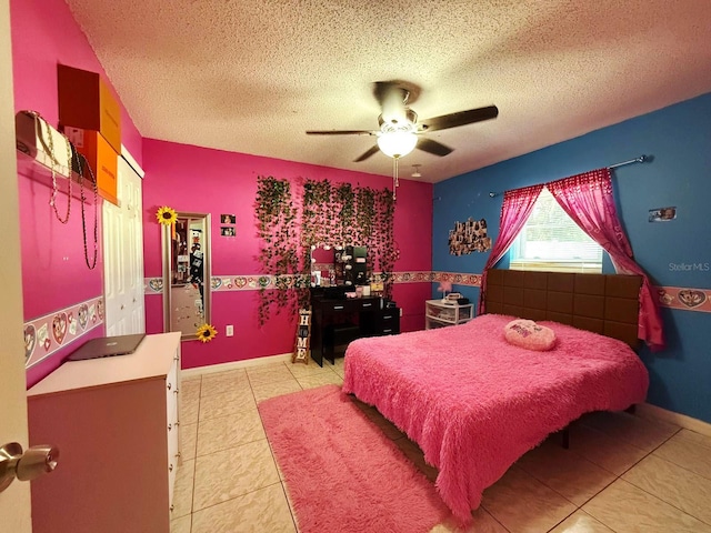 tiled bedroom featuring ceiling fan and a textured ceiling