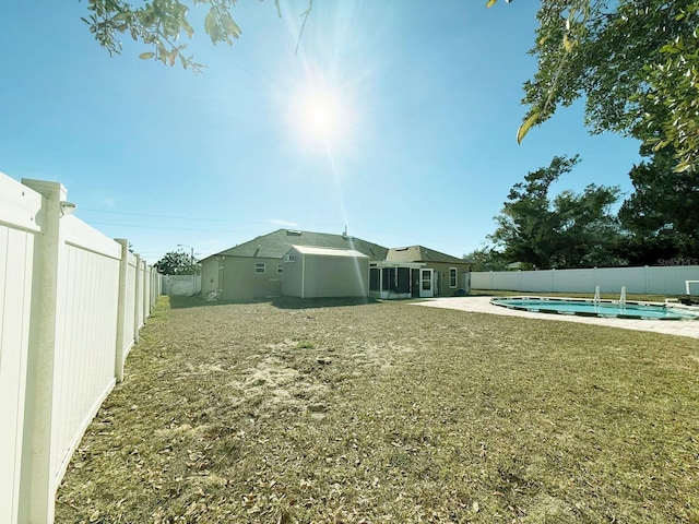 view of yard with a fenced in pool and a patio