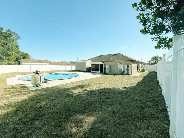 view of swimming pool with a yard, a patio area, and central air condition unit