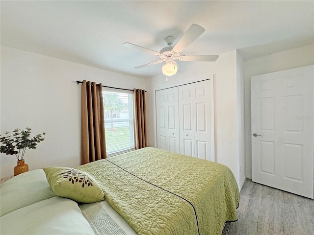 bedroom with a closet, ceiling fan, and light wood-type flooring