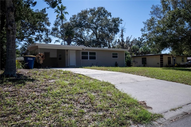 single story home featuring a front yard and a carport