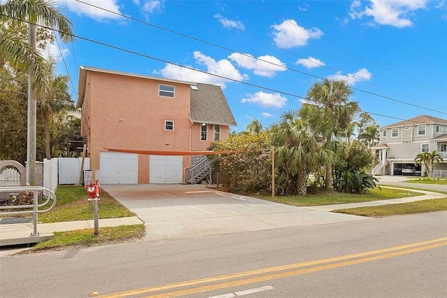 view of home's exterior with a yard and a garage