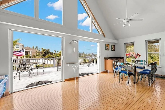 sunroom / solarium with ceiling fan and lofted ceiling